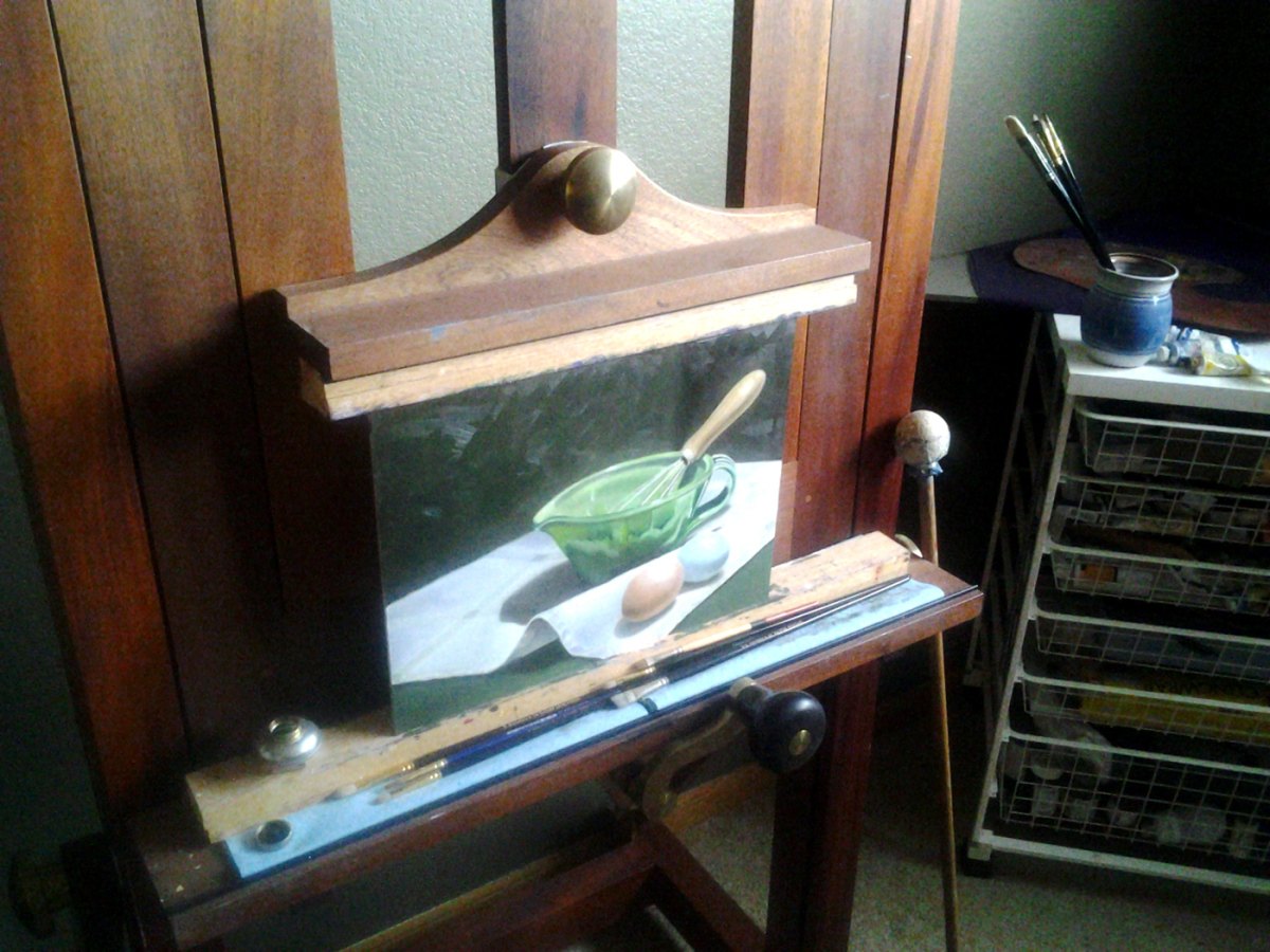 A still life in progress on a wooden studio easel